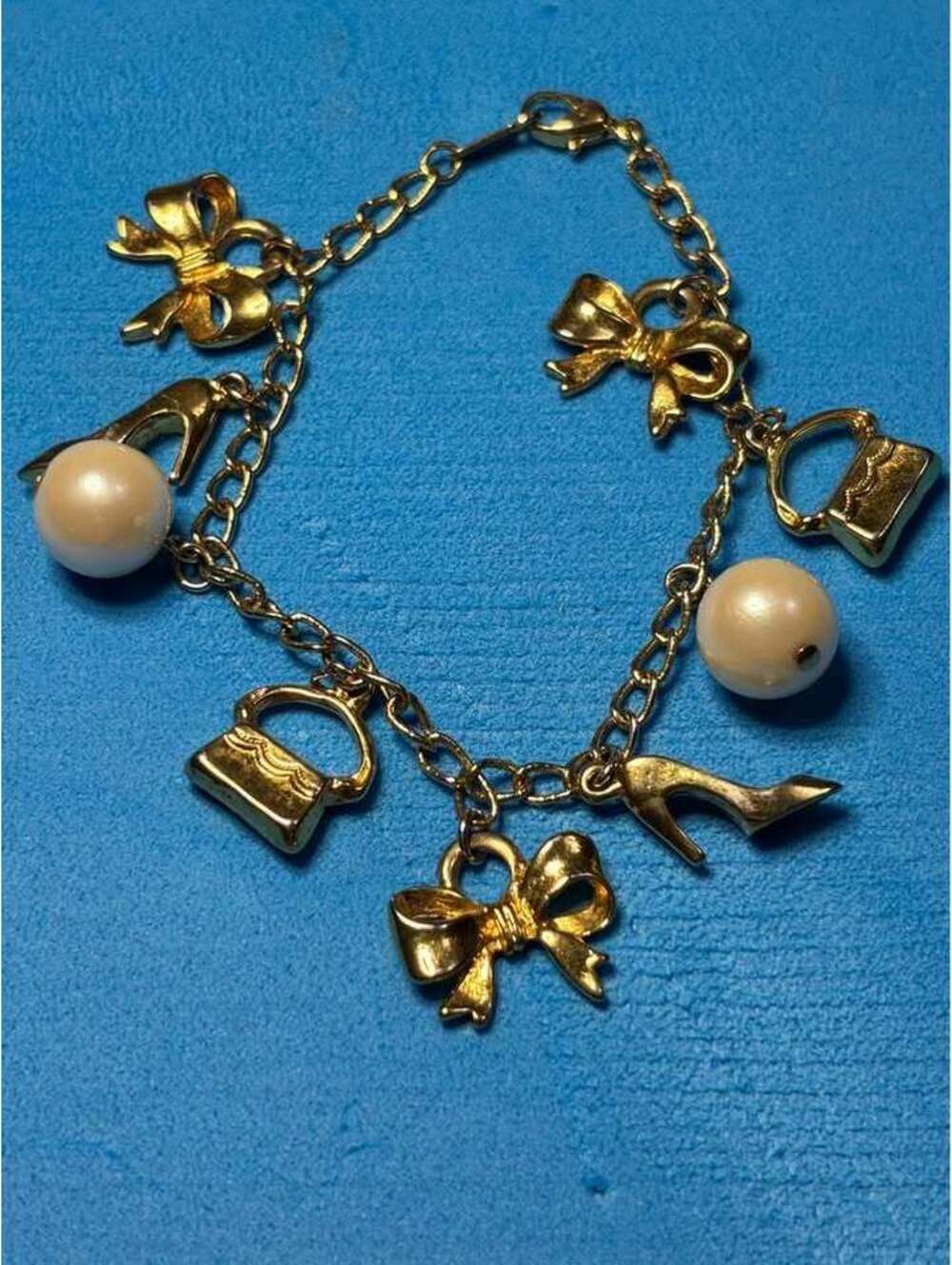 Gold Tone Charm Bracelet with Bows, Purses, and Faux Pearls